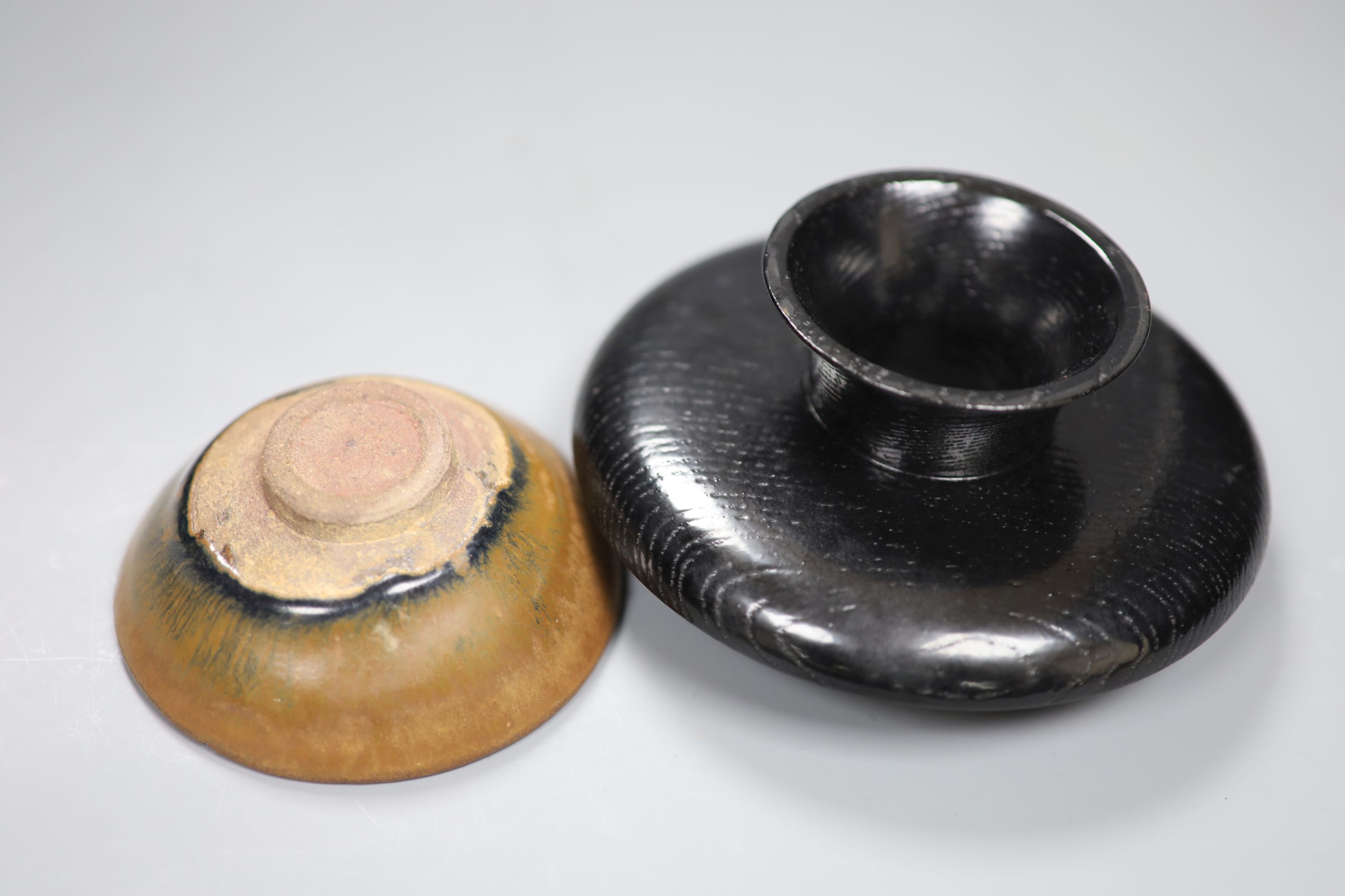 A Chinese Tenmoku tea bowl, diameter 9.5cm, and a lacquer stand